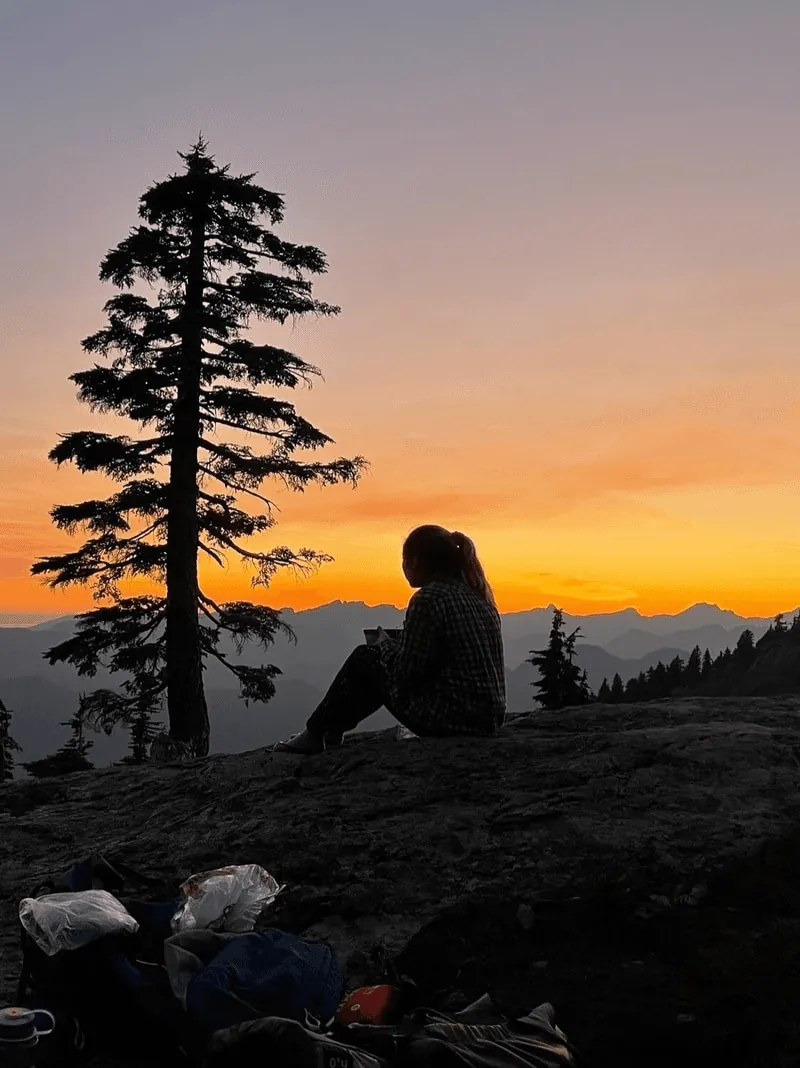 Novia at a summit at sunset